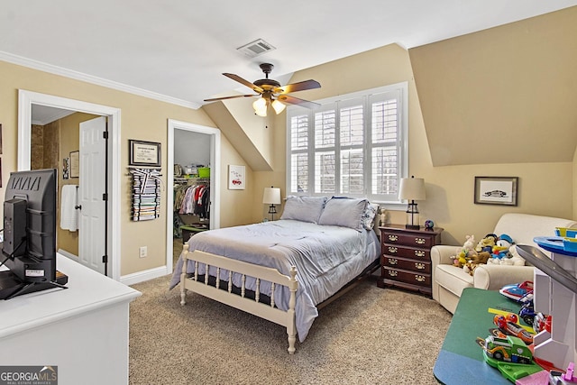 bedroom with lofted ceiling, a walk in closet, light carpet, ornamental molding, and ceiling fan