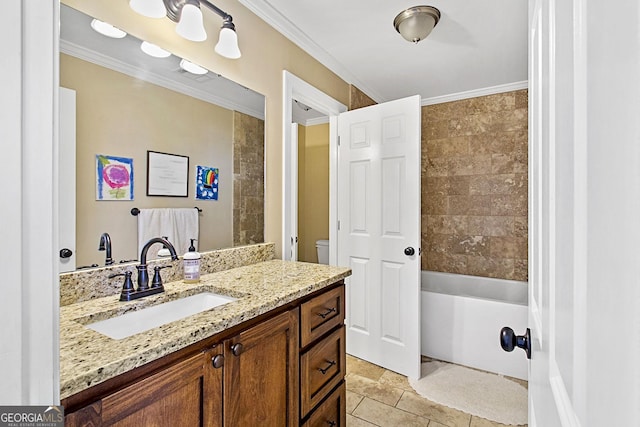 full bathroom with vanity, tiled shower / bath, ornamental molding, and toilet