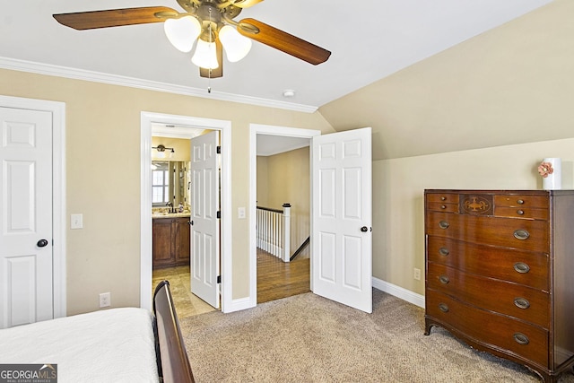 bedroom featuring crown molding, ceiling fan, ensuite bathroom, vaulted ceiling, and light colored carpet