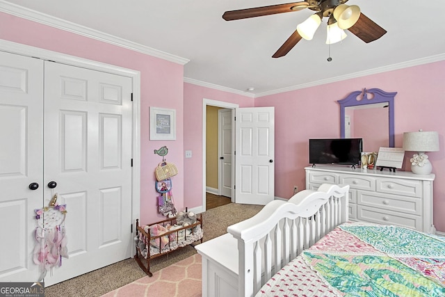 bedroom with crown molding, ceiling fan, light colored carpet, and a closet