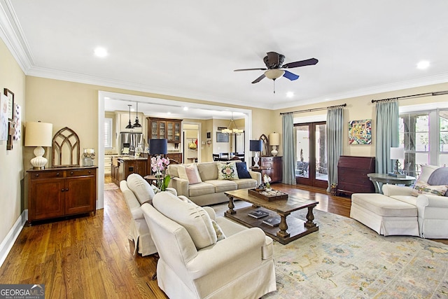 living room featuring ornamental molding, a healthy amount of sunlight, and dark hardwood / wood-style floors