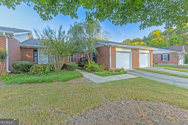 single story home with a garage and a front lawn