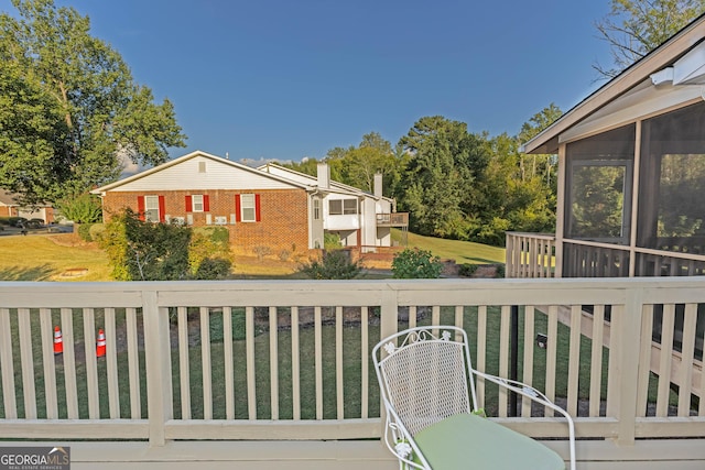 wooden deck featuring a yard