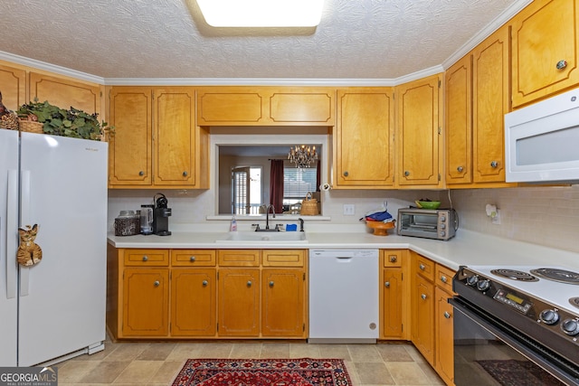 kitchen with white appliances, sink, decorative backsplash, and a textured ceiling