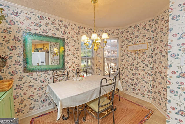 tiled dining area featuring ornamental molding, a textured ceiling, and a chandelier