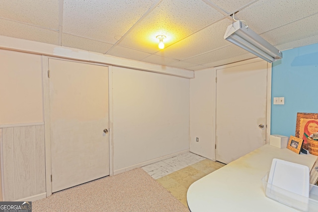 basement featuring a paneled ceiling