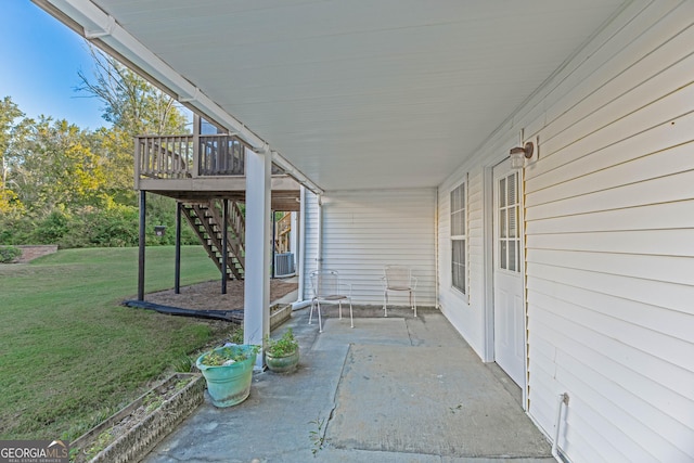 view of patio with cooling unit and a deck