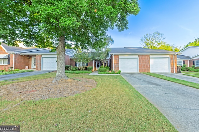 ranch-style house featuring a garage and a front lawn