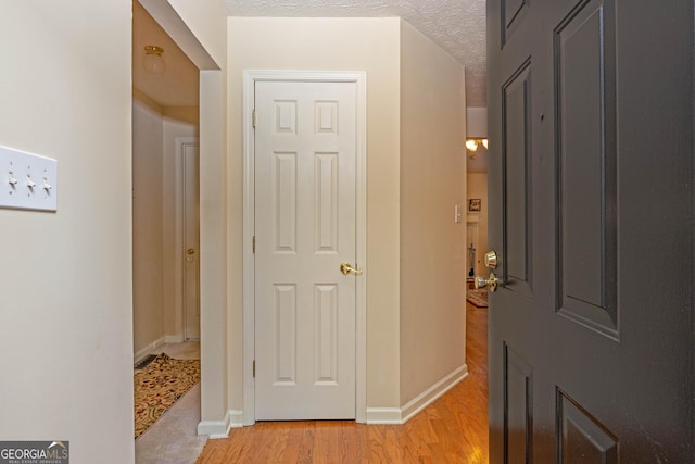 foyer featuring light hardwood / wood-style floors and a textured ceiling