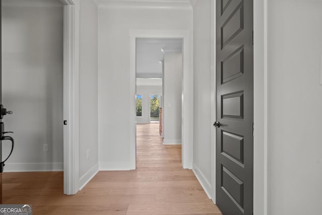 corridor with light hardwood / wood-style floors