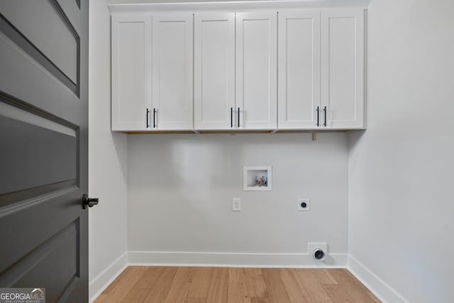 laundry room featuring washer hookup, cabinets, light hardwood / wood-style flooring, and hookup for an electric dryer