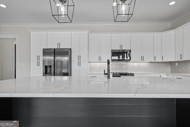 kitchen with light stone countertops, appliances with stainless steel finishes, a center island, and pendant lighting