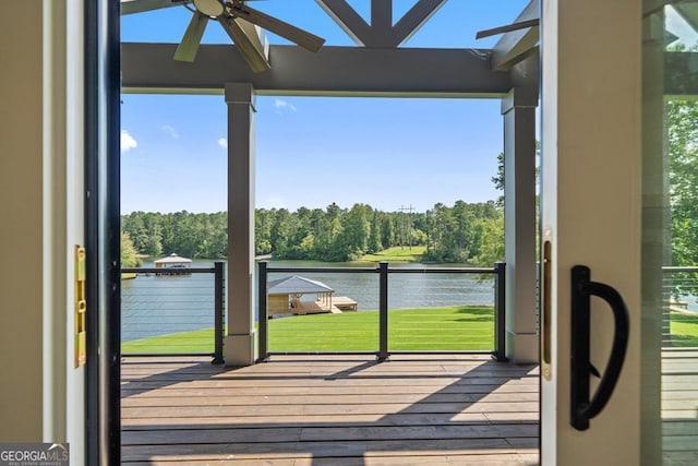 doorway to outside featuring hardwood / wood-style floors, ceiling fan, and a water view