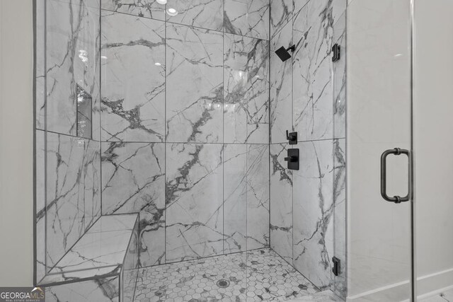 bathroom with a shower with door