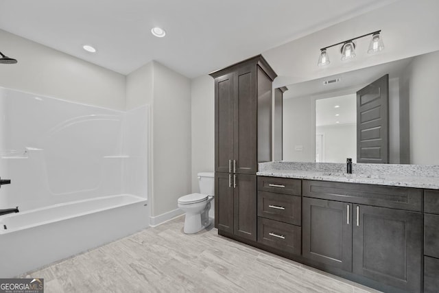 full bathroom featuring shower / tub combination, vanity, and toilet