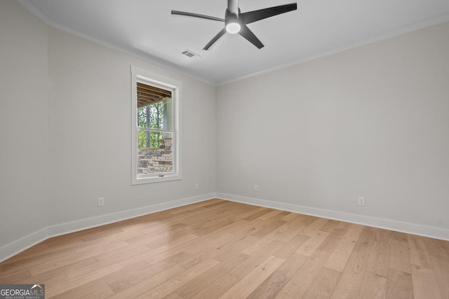 empty room featuring ornamental molding, ceiling fan, and light wood-type flooring