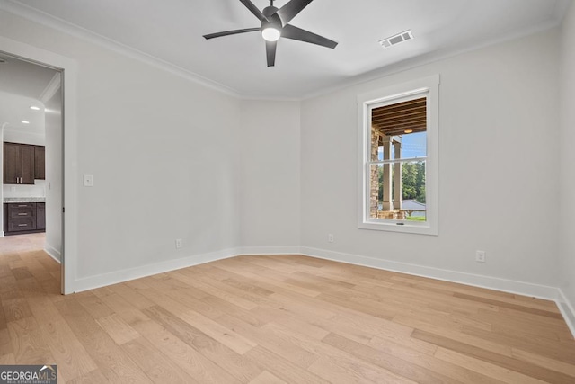 unfurnished room featuring ornamental molding, light hardwood / wood-style floors, and ceiling fan