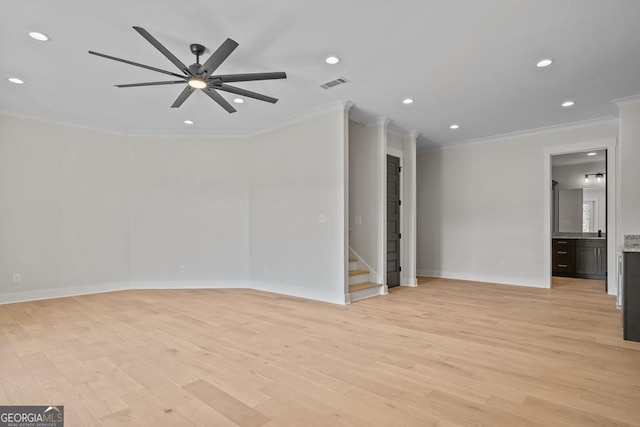 unfurnished room with ceiling fan, ornamental molding, and light wood-type flooring