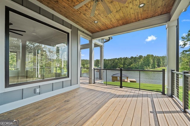 wooden deck featuring a water view and ceiling fan