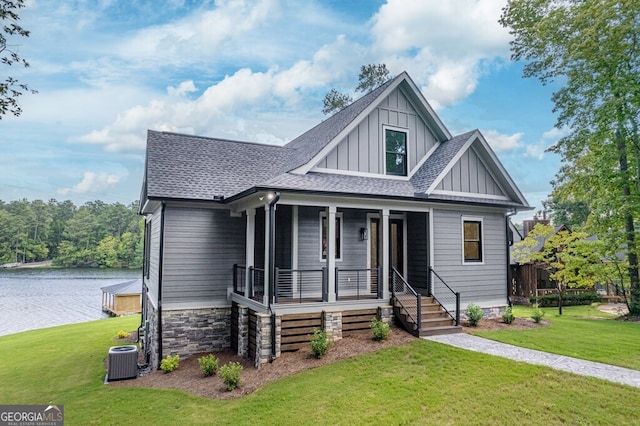 view of front of property featuring a water view, central AC, and a front yard