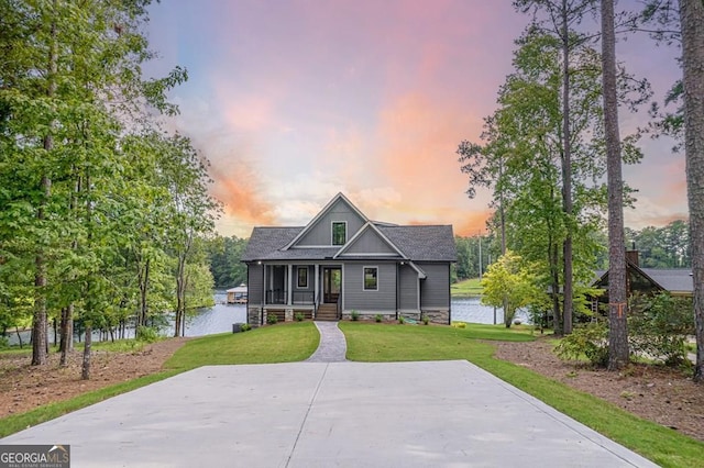 view of front of property featuring a water view and a yard