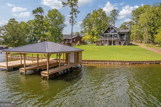 dock area with a yard and a water view