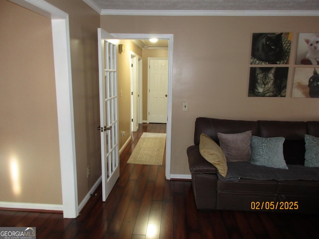 living room featuring dark hardwood / wood-style flooring and ornamental molding