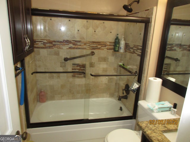 full bathroom featuring vanity, toilet, and combined bath / shower with glass door