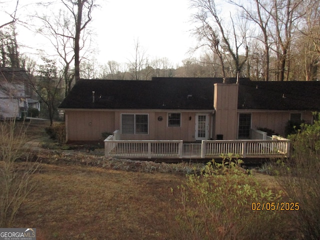 rear view of property with a wooden deck