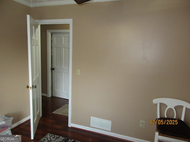 interior space with crown molding and dark hardwood / wood-style flooring