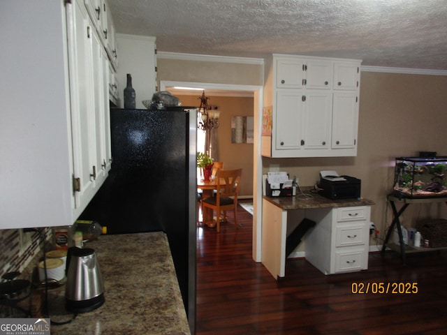 kitchen with white cabinetry, dark wood-type flooring, ornamental molding, and a textured ceiling