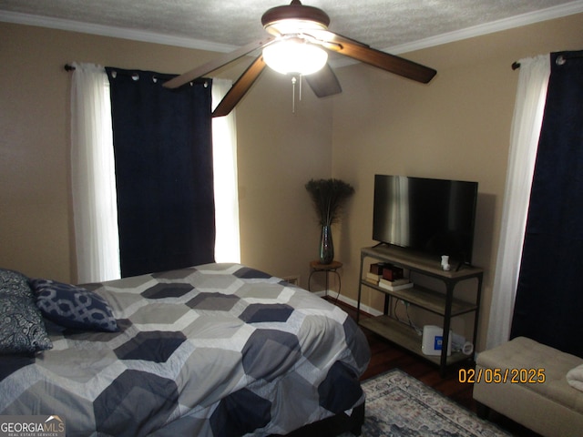 bedroom featuring hardwood / wood-style flooring, ceiling fan, and ornamental molding