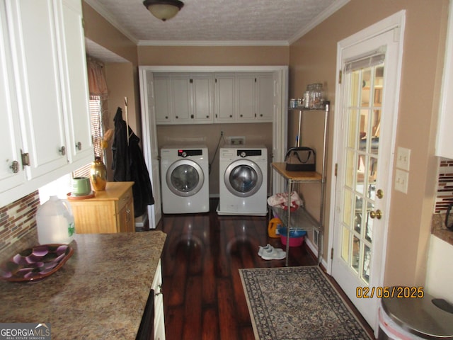 laundry room featuring dark hardwood / wood-style floors, cabinets, ornamental molding, washing machine and dryer, and a textured ceiling