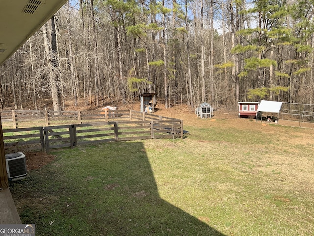 view of yard featuring cooling unit and a storage unit