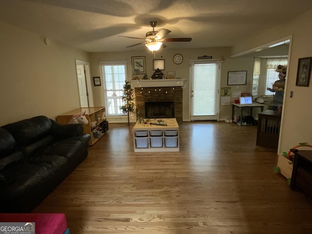 living room with hardwood / wood-style floors and ceiling fan