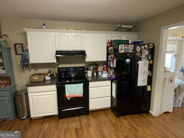 kitchen featuring a textured ceiling, black appliances, light hardwood / wood-style floors, and white cabinets