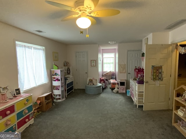 recreation room featuring dark carpet