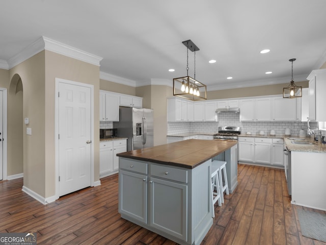 kitchen with gray cabinets, stainless steel appliances, a center island, and white cabinets