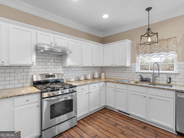 kitchen featuring white cabinetry, appliances with stainless steel finishes, sink, and decorative light fixtures