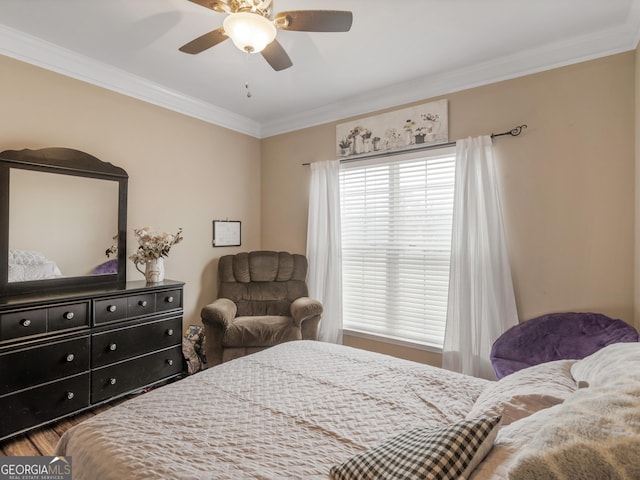 bedroom featuring ornamental molding, hardwood / wood-style floors, and ceiling fan