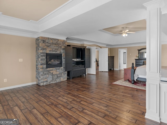 living room with crown molding, dark wood-type flooring, and a raised ceiling