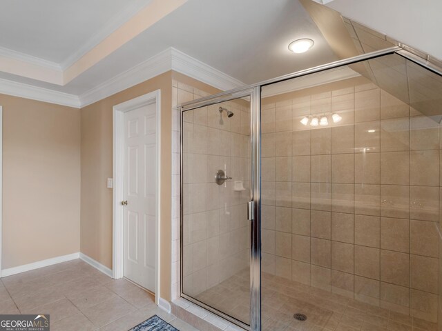 bathroom featuring crown molding, a shower with door, and tile patterned floors