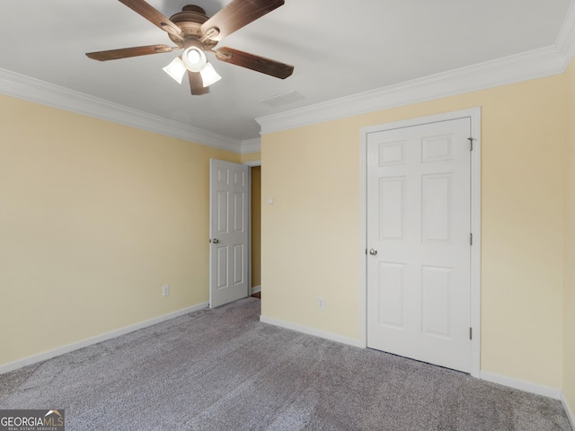 unfurnished bedroom with ornamental molding, carpet, and ceiling fan