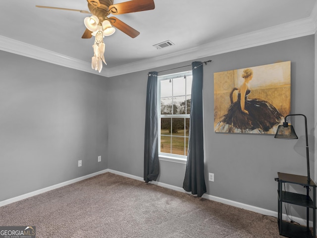 carpeted spare room with crown molding and ceiling fan