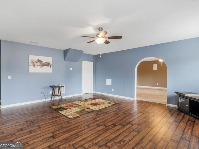 living room with dark hardwood / wood-style floors and ceiling fan