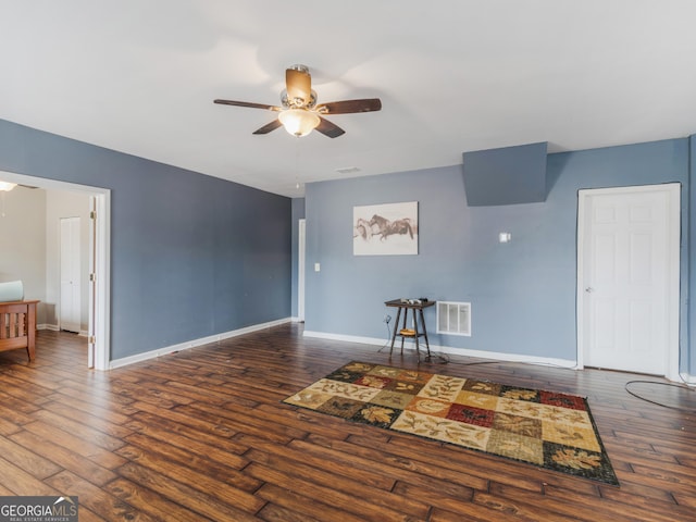 unfurnished living room with ceiling fan and dark hardwood / wood-style floors