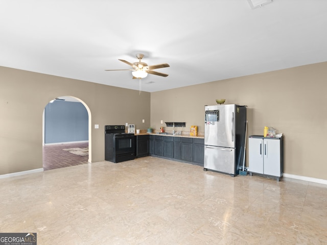 kitchen with electric range, stainless steel fridge, and ceiling fan