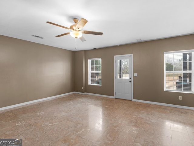 spare room with ceiling fan