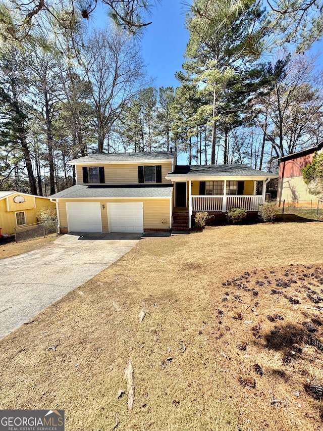 split level home with a garage, driveway, and a porch