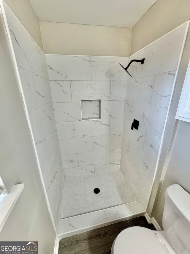 full bath with a shower stall and toilet